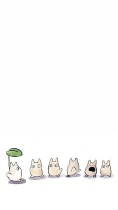 a line of cats sitting in front of a green umbrella on top of a white surface