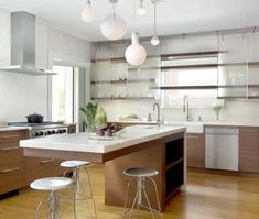 a kitchen with wooden floors and white counter tops