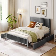 a bed sitting on top of a wooden floor next to a window