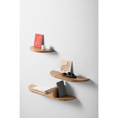 two wooden shelves with books on them