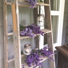 a wooden ladder with purple flowers on it