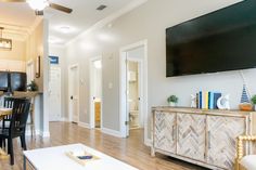 a large flat screen tv mounted to the side of a wall in a living room