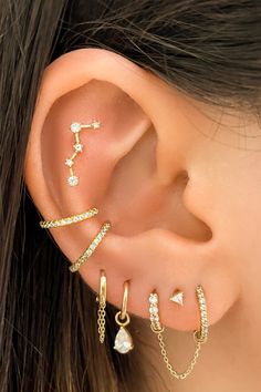 a woman wearing three different ear piercings