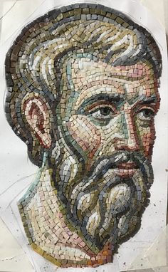 a mosaic portrait of a bearded man with long hair and beard, on white paper