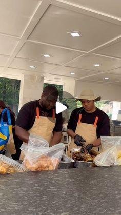 two men in aprons are preparing food at the counter with bags on each side