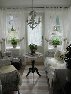 a living room filled with furniture and windows