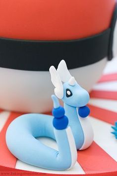 a blue and white dragon figurine sitting on top of a red and white table