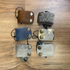 four different types of purses sitting on top of a wooden floor