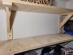 the shelves are made from plywood and have wooden wheels on them, along with other tools