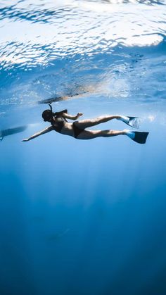 a woman is swimming in the water