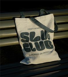 a white bag sitting on top of a metal bench