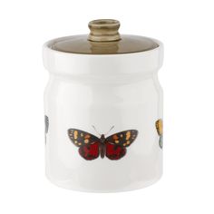 a white jar with a butterfly painted on it