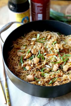 a pan filled with noodles and vegetables on top of a table