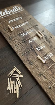 a wooden board with pins and clothes pins laid out on the floor next to it