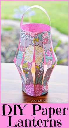 a paper lantern sitting on top of a wooden table next to a pink and white sign that says diy paper lanterns