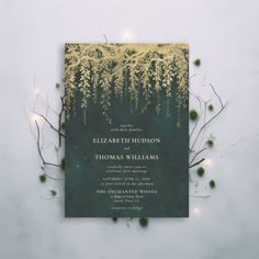 a green and gold wedding card with greenery