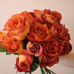 a bouquet of orange roses in a vase