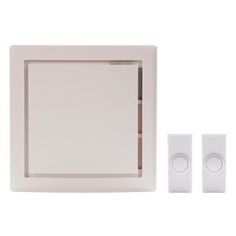 a white wall mounted light switch and two switches