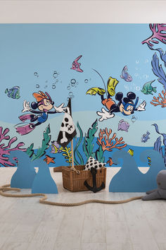 an underwater scene painted on the wall in a children's room with toys and decorations