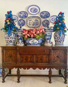 blue and white vases are on top of an old dresser