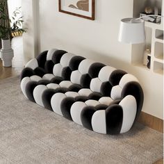 a black and white couch sitting on top of a rug