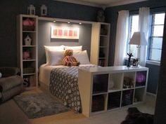 a teddy bear sitting on top of a bed in a bedroom