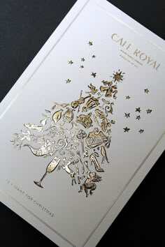 a white card with gold foil on it