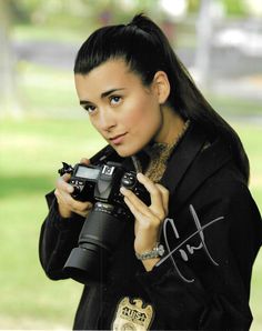 a woman holding a camera in her hands