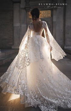 the back of a wedding dress with an intricate lace pattern and long sleeves is shown