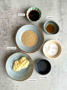 four bowls with different types of food in them on a gray surface, one bowl has an egg and the other two are empty