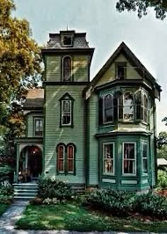 a large green house sitting on top of a lush green field