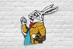 a white brick wall with an image of a rabbit wearing a yellow shirt and red tie