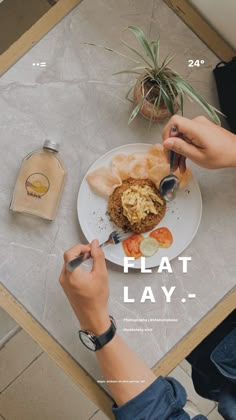 a person sitting at a table with a plate of food in front of them and the words flat lay on it