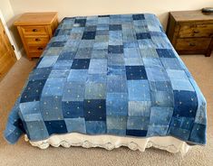 a blue bedspread with gold stars is on the floor in front of two dressers