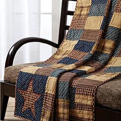 a chair with a quilted blanket on top of it and a wooden arm rest