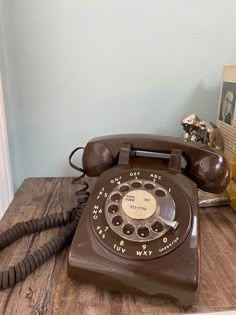 an old fashioned telephone sitting on a wooden table