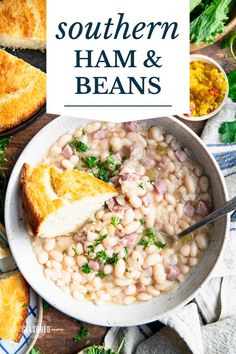 white bean soup with ham and beans in a bowl next to bread on a wooden table