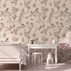 a pink wallpaper with birds and branches on it, next to a white dresser