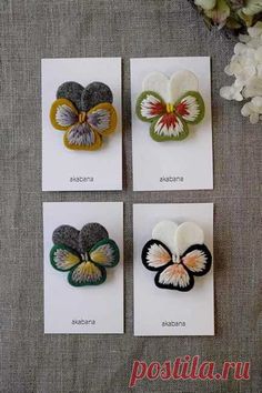 four different types of buttons with flowers in the middle and on each one's side