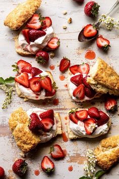 strawberry shortcakes with whipped cream and fresh strawberries on the side, ready to be eaten