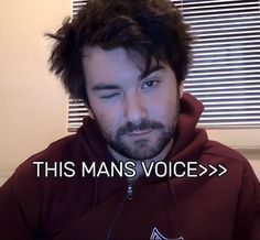 a man wearing a maroon hoodie with the words this mans voice in front of him