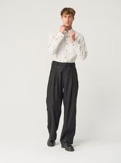 "Exquisite linen trousers for men -- flowy, pleated, and packed with details that ensure impeccable fit. Offered in heavy-weight linen. If you're interested in a medium-weight option, you'll find another THEO listing in our MEN'S section. STYLE DETAILS  * Relaxed fit * Wide, straight leg * High waist with elasticated back  * 2 front pleats * Fastens with 2 buttons and a zipper * Side pockets * Full length * Made from heavy-weight linen SIZES & COLORS IN PICTURES * Model wears size L in color Black Heavy and size M in color Magnetic Blue. He is 188 cm (6'2\"). Chest - 97 cm (38\"), waist - 83 cm (33\"), hips - 97 cm (38\"). NOTES ON SIZING & COLORS * Please note that linen shrinkage during the softening process cannot be predicted precisely. Therefore, each piece in the same size can vary 1 Mens Flowy Fashion, Male Linen Pants, Wide Trousers Outfit Men, Wide Pleated Pants Outfit Men, High Waisted Trousers Men, Wide Leg Trousers Outfit Men, Wide Fit Pants Men, Mens Wide Pants, Linen Trousers Outfit Men