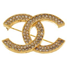 Chanel gold CC rhinestone brooch with gold-tone hardware, CC logo with rhinestones, and pin closure. 770072MSC Rhinestone Brooches, Gold Tones, Chanel, Gold