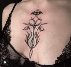 a woman's chest with an eye and flower tattoo on her left side ribcage