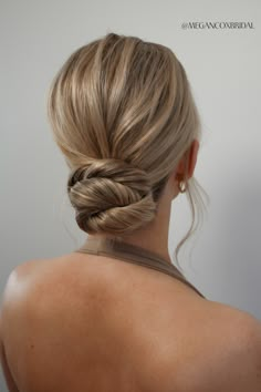 the back of a woman's head with her hair in a braid