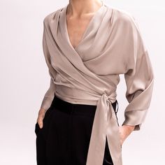 Easy and versatile, this blouse is crafted from high quality viscose fabric and has wide kimono sleeves. It is designed to wrap & tie in different ways. Wrap it around the waist and tie the straps at the front side, for a more classic look. Or cross the straps in the middle front (semi-tie, braided) and then wrap them around the waist and tie them either on the back or the front.  Pair it with its coordinating bias-cut skirt from the collection.   All pieces are cut one by one for an impeccable Soft Dramatic Clothing, Soft Classic Skirts Kibbe, Cross Blouse Designs, Wrap Blouse Outfit, Wrap Around Shirt, Wrap Skirt Outfit, Formal Wrap, Satin Wrap Top, Large Roses