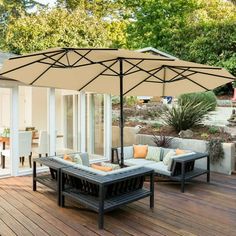 an outdoor patio with furniture and an umbrella