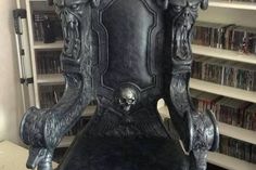 a chair that is sitting in front of a book shelf