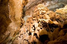 the inside of a cave with rocks and water flowing down it's sides,