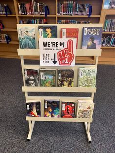 there is a book display in the library with books on it and a sign that says we're 1